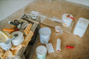 Een expert voert vloerreparatie uit in een moderne woning met beschadigde vloer.